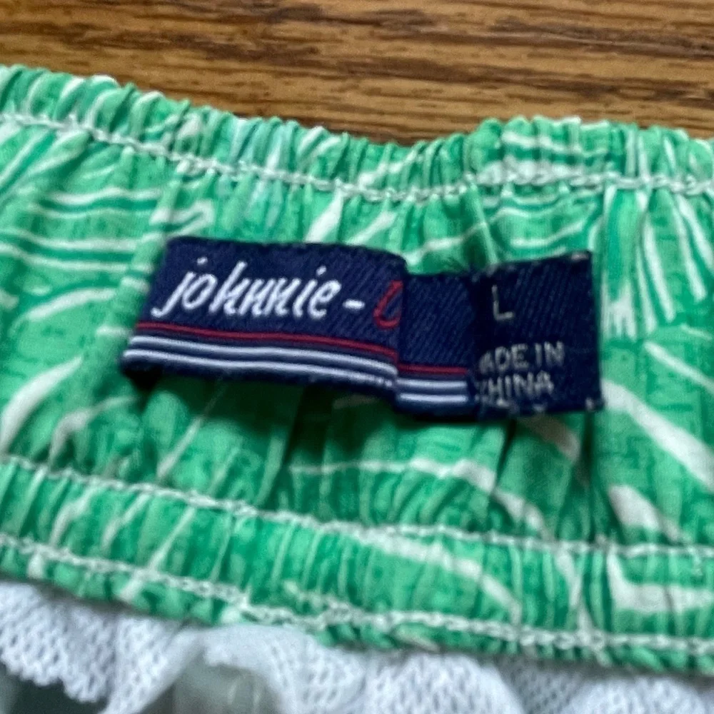 Johnnie-O swim shorts- green leaf design- size men’s large elastic in back.